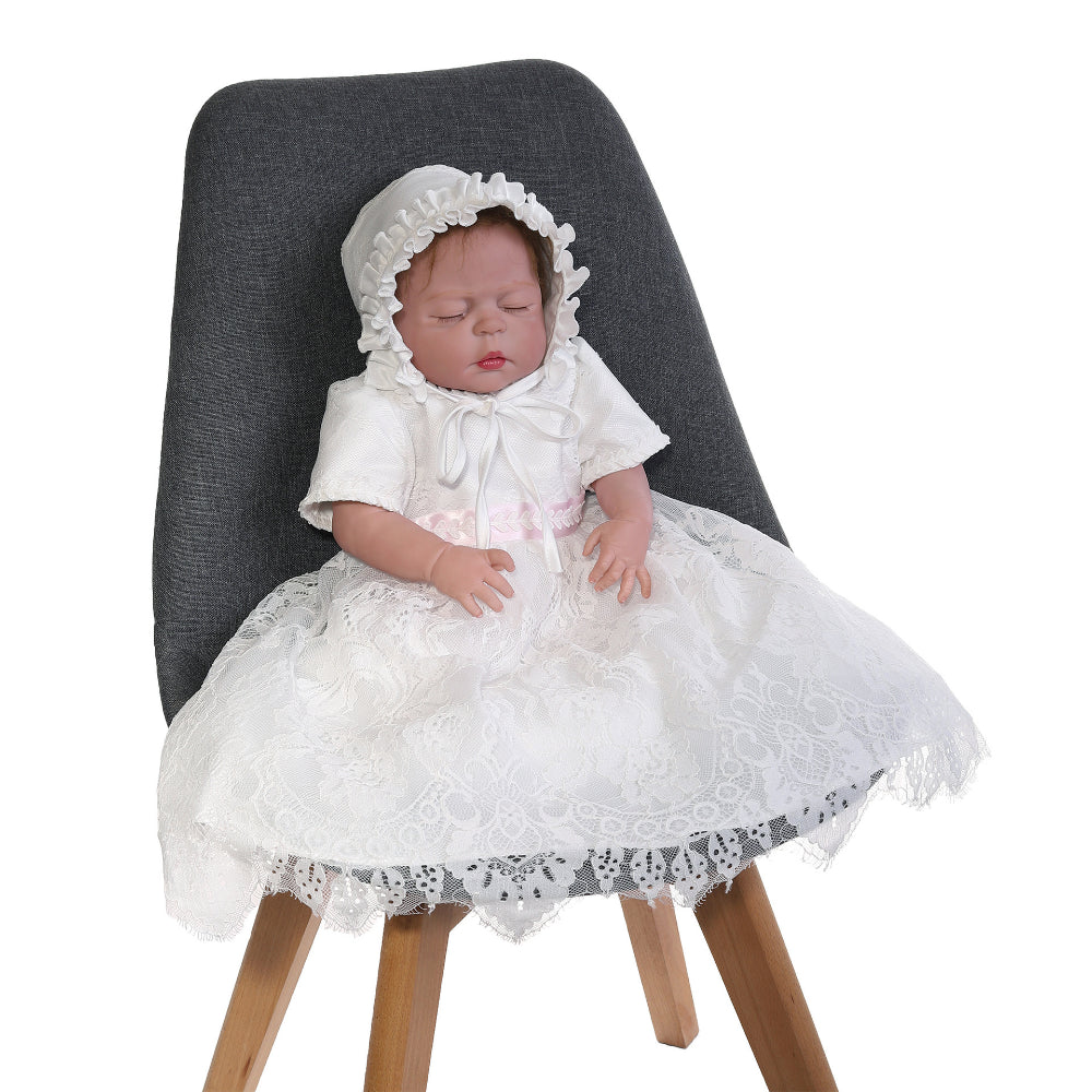 Baby in a white dress and bonnet meejoy.com.au